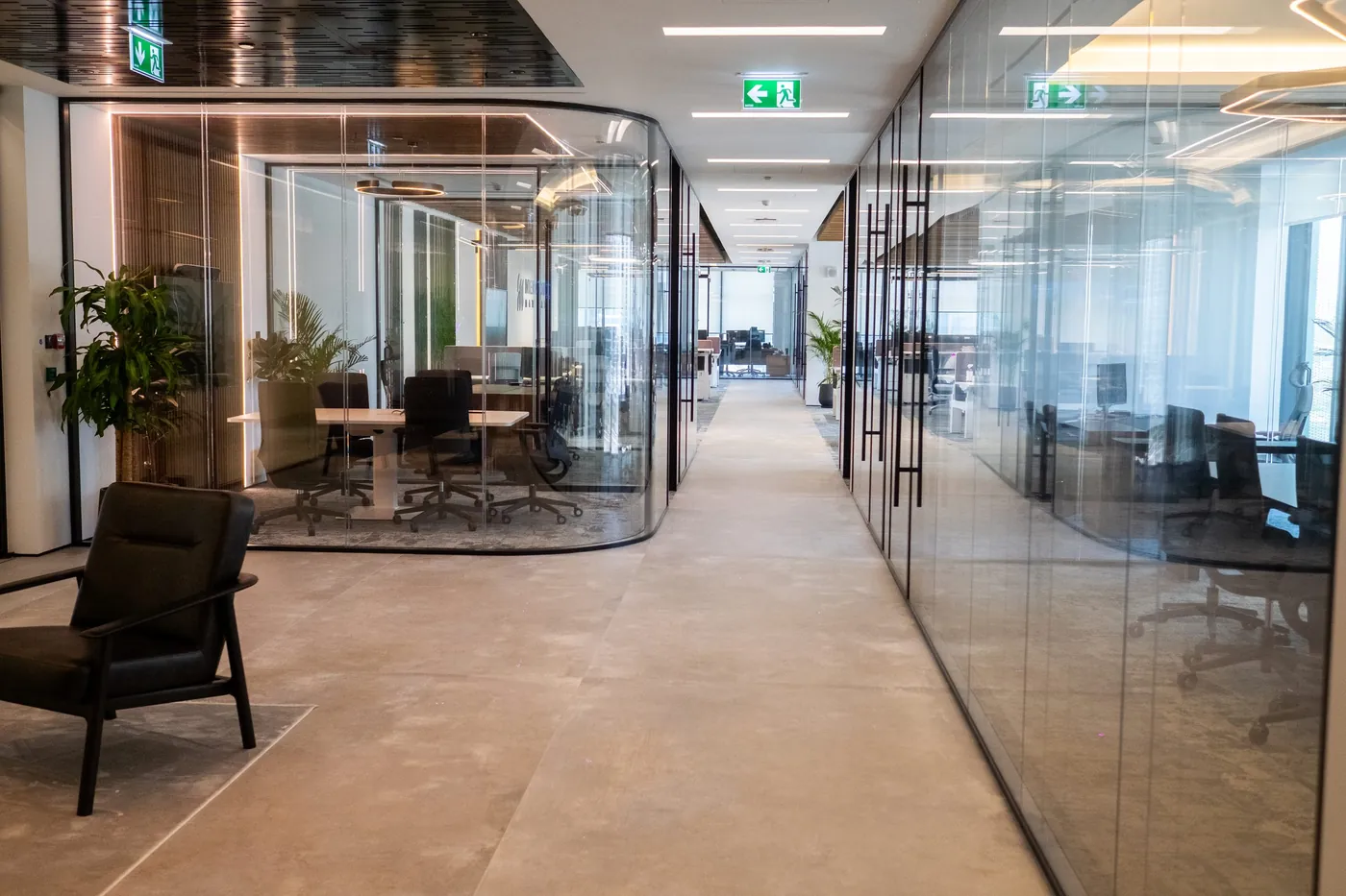 Glass offices along a corridor, IMI at One Za’abeel