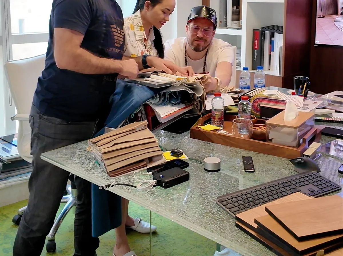 Fajr Interiors designers and a client going through veneer and fabric samples at the studio