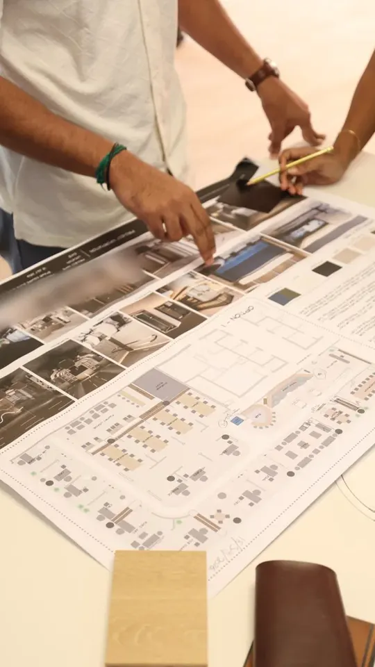 Fajr Interiors design team reviewing drawings at the studio table