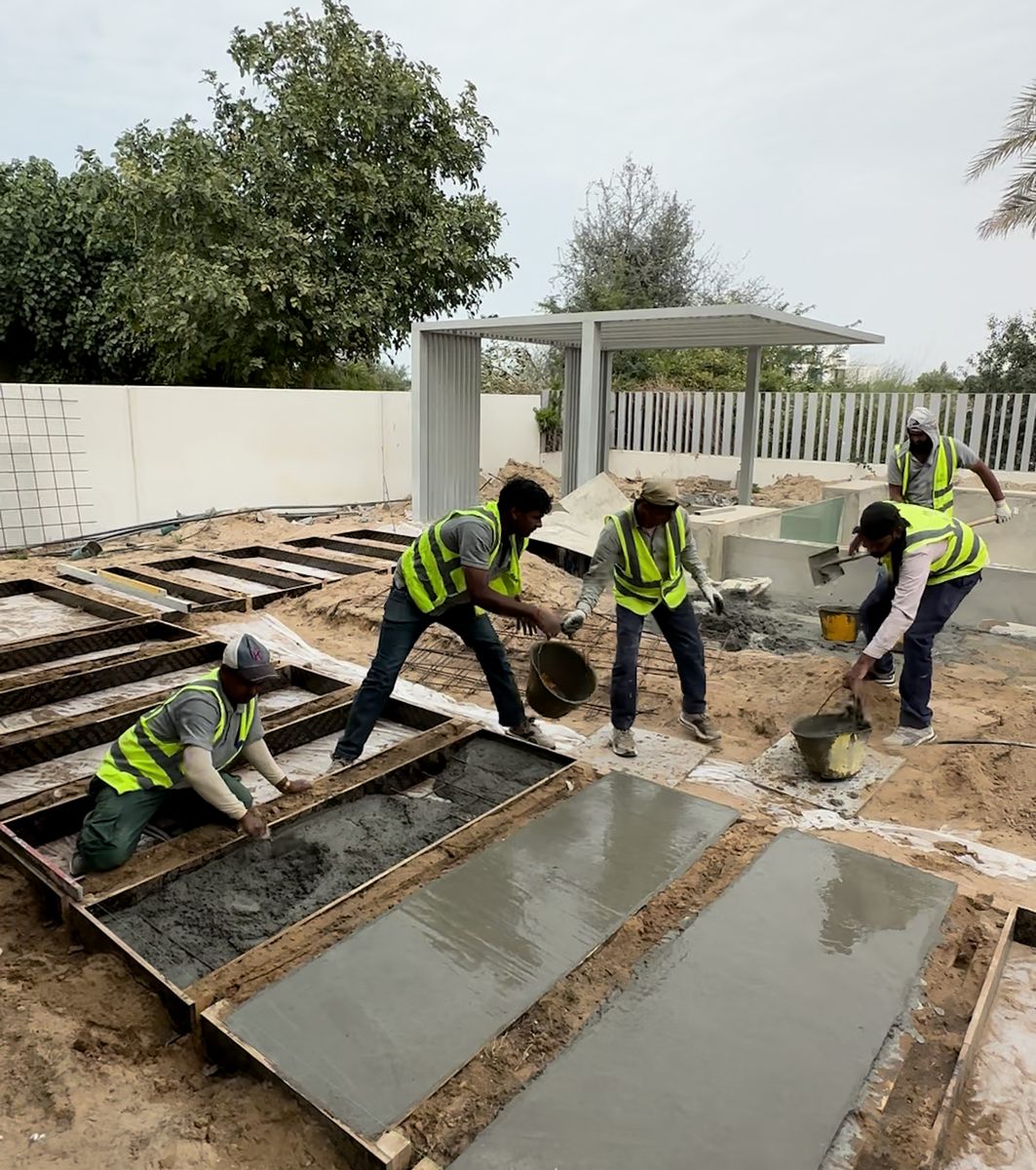 Fajr site team forming and pouring screed beds in a villa garden during a renovation, Dubai