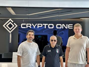 The client and the Fajr team in front of the Crypto One sign