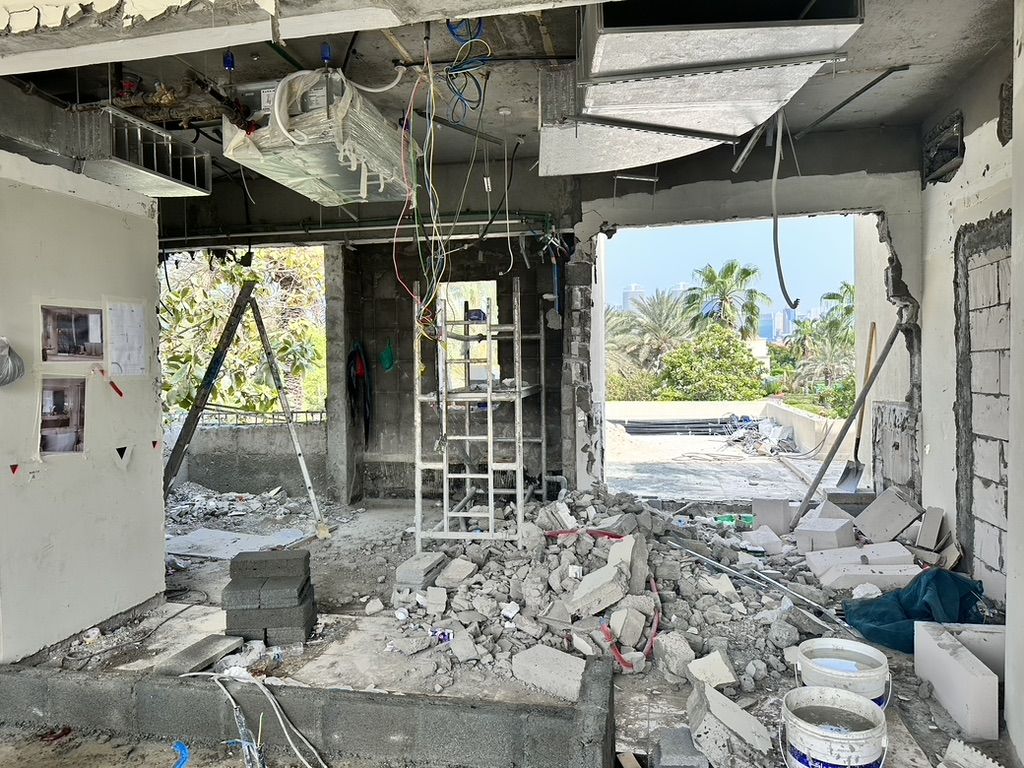 A villa opened up for the works on a Fajr site: walls and ceilings stripped back, services exposed