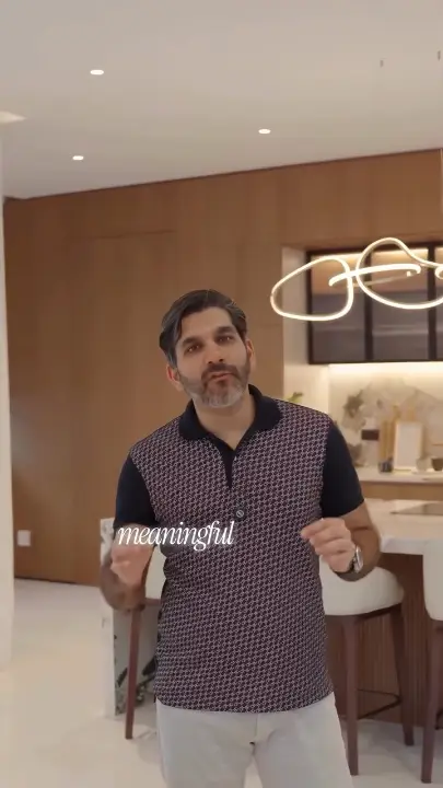 The founder of Fajr Interiors in a finished villa kitchen, beside the island, Dubai