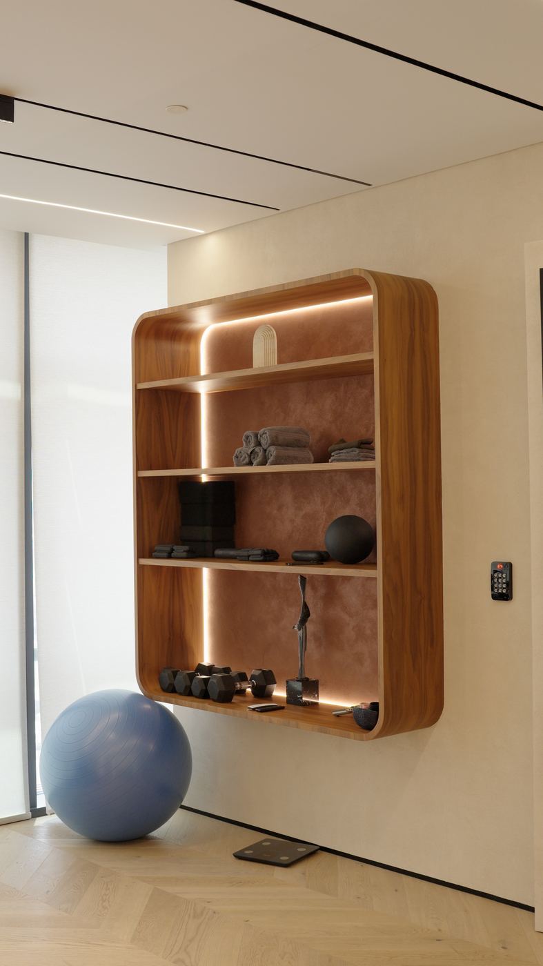 Wellness room with a lit timber wall shelf and gym equipment, delivered by Fajr Interiors, Dubai