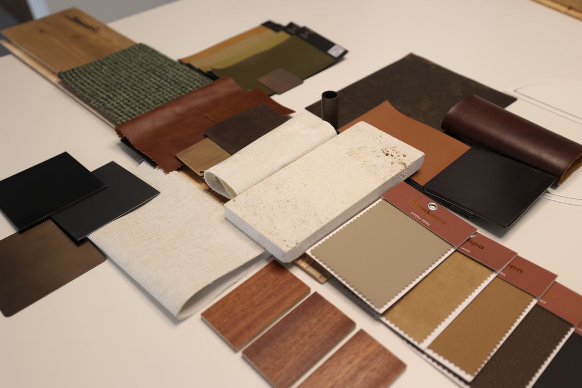 Stone, timber veneer, leather and fabric samples laid out for an office concept at the Fajr Interiors studio