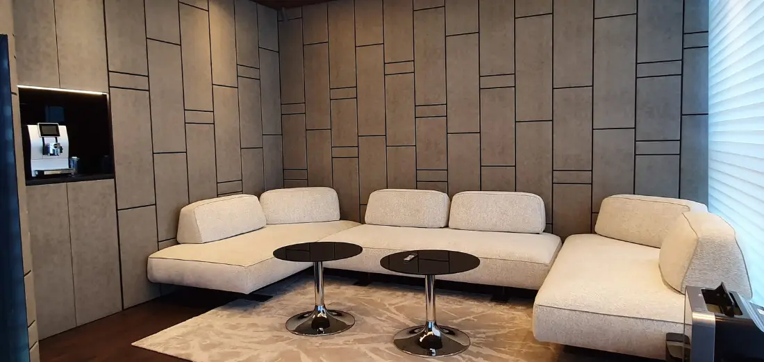 Lounge with white modular sofas against panelled walls, delivered by Fajr Interiors for AlSubeai Investments, Jeddah
