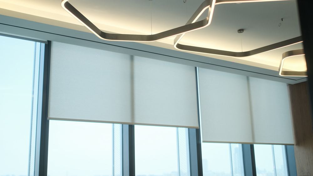 Motorised roller blinds along a window line, Jumeirah Islands villa by Fajr Interiors