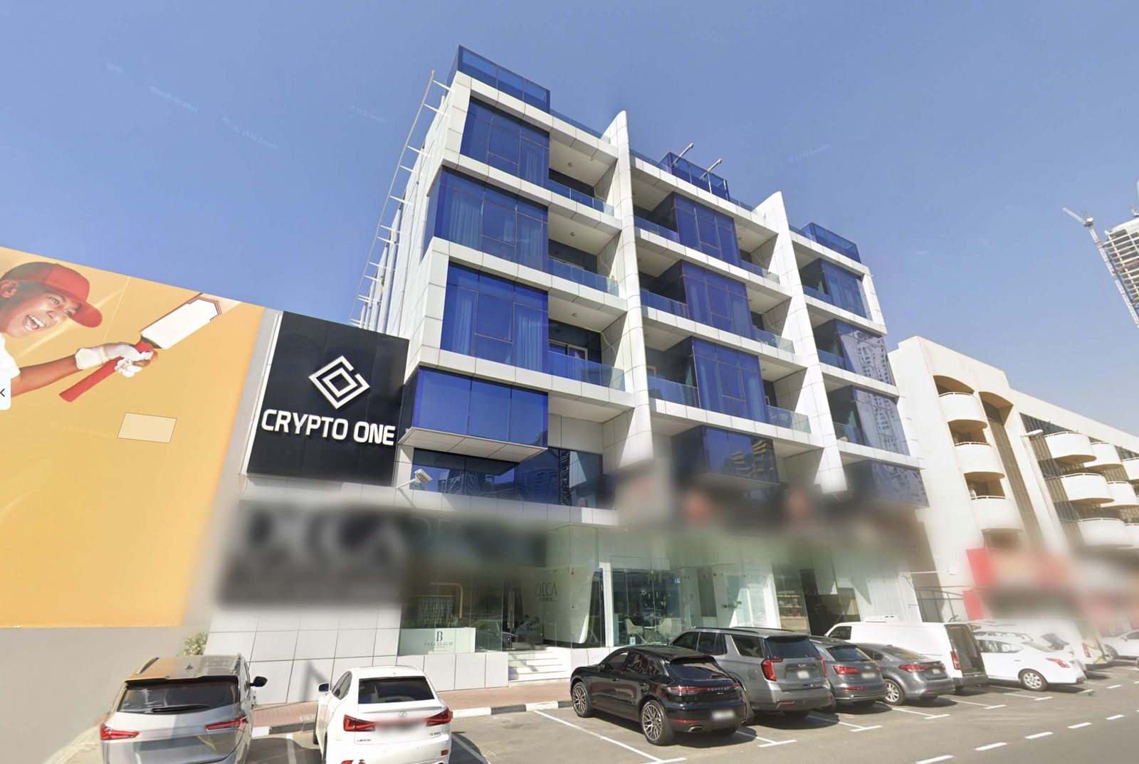 The Crypto One building on Sheikh Zayed Road, Dubai, with the Crypto One sign on the facade