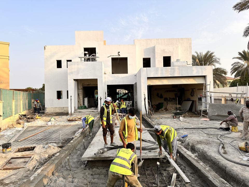Villa renovation on site: the crew pouring the driveway slab