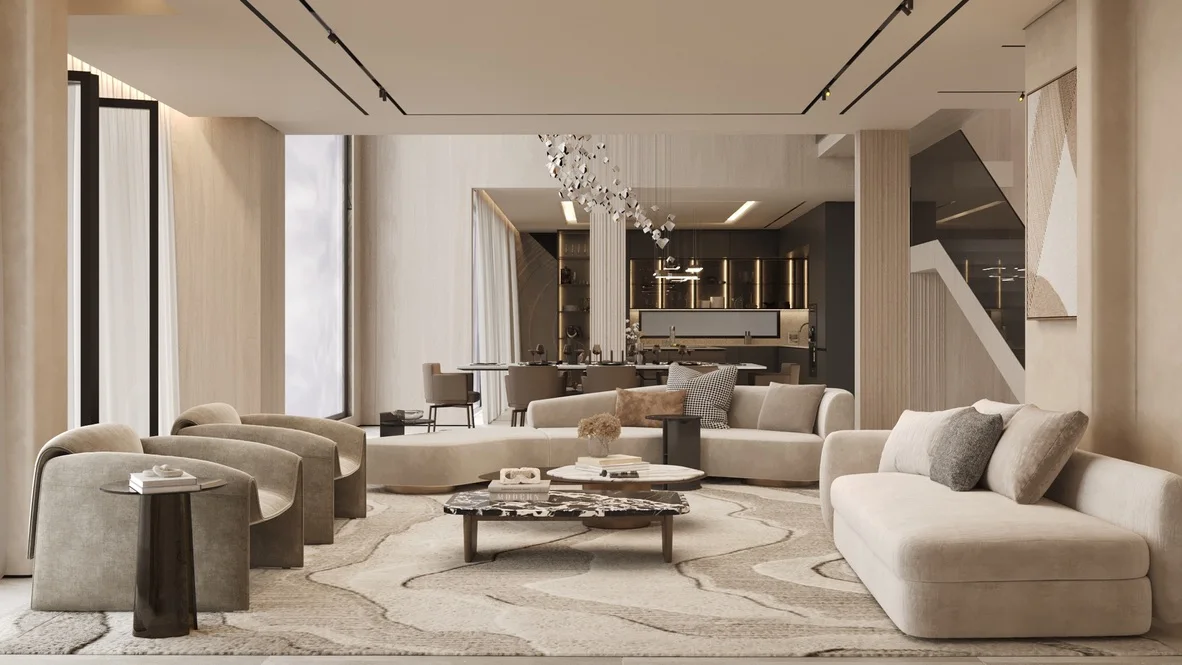 Render: villa living room with sculpted lounge chairs, curved sofas and a marble coffee table, the dining table and dark-glass kitchen joinery beyond