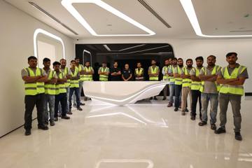 The Fajr site team lined up at the Crypto One reception desk on handover day