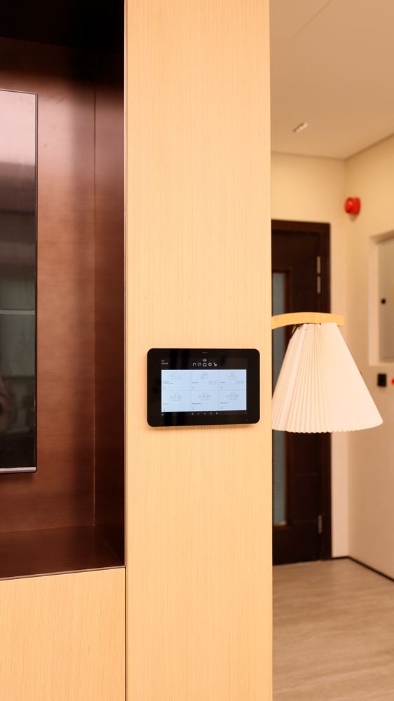 Wall-mounted scene control panel beside a meeting room door, fitted by Fajr Interiors, Dubai