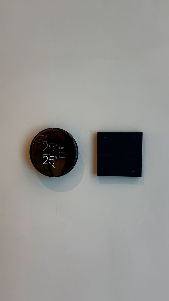 Thermostat and scene keypad on an office wall, fitted by Fajr Interiors, Dubai