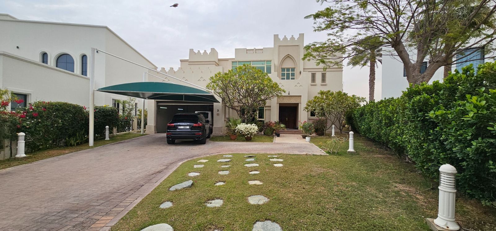 Cluster 39, Villa 3, Jumeirah Islands: the villa front with its arched windows and carport, before the works