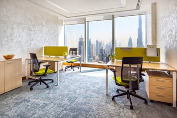 Workstations at Serene, Vision Tower, with green screens and a view of the Downtown towers, Dubai