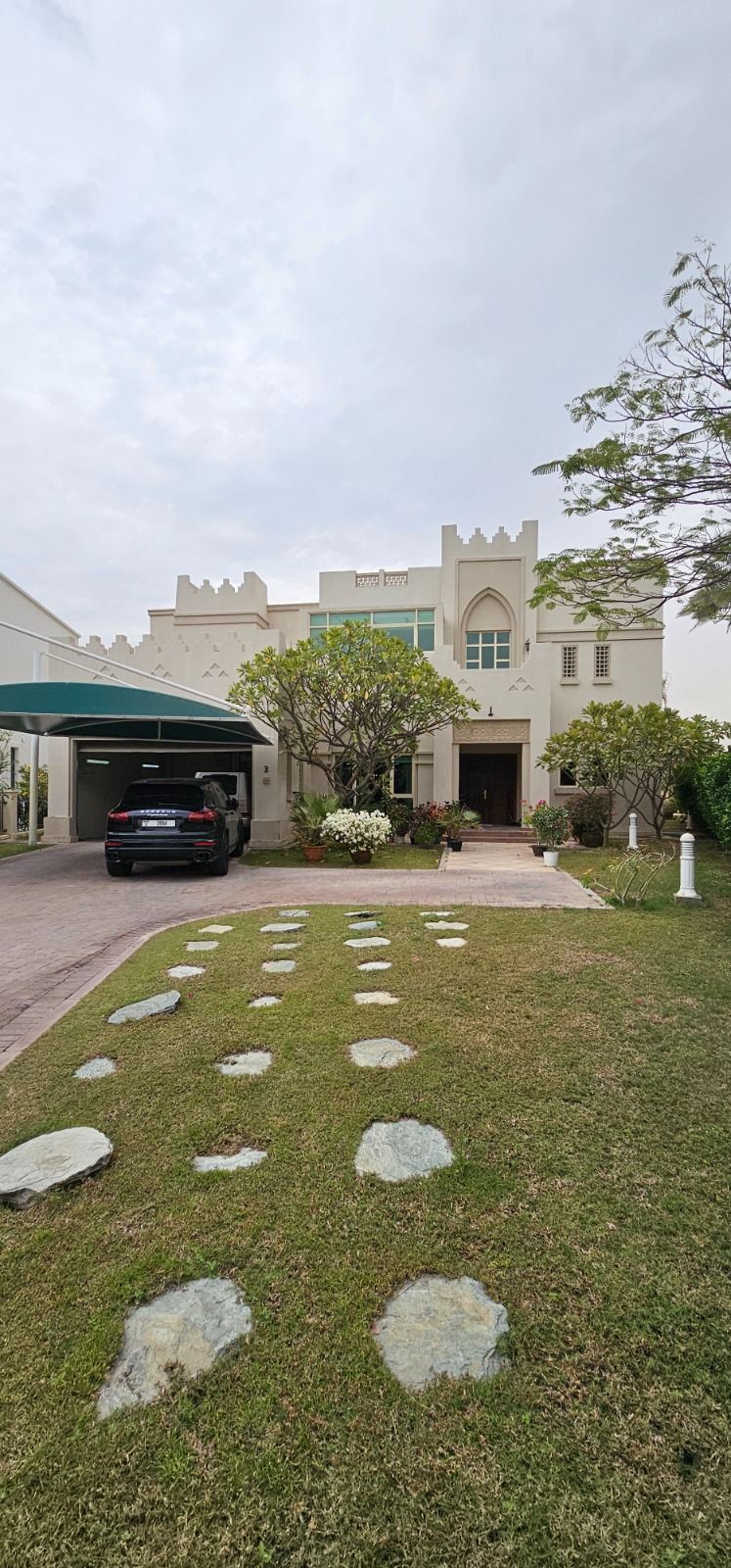 The approach to Cluster 39, Villa 3, Jumeirah Islands: stepping stones across the lawn to the villa