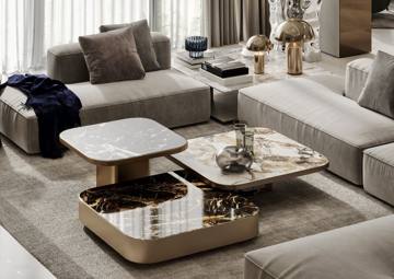 Render of the lounge at Villa 389: a low sofa around nested marble and bronze coffee tables