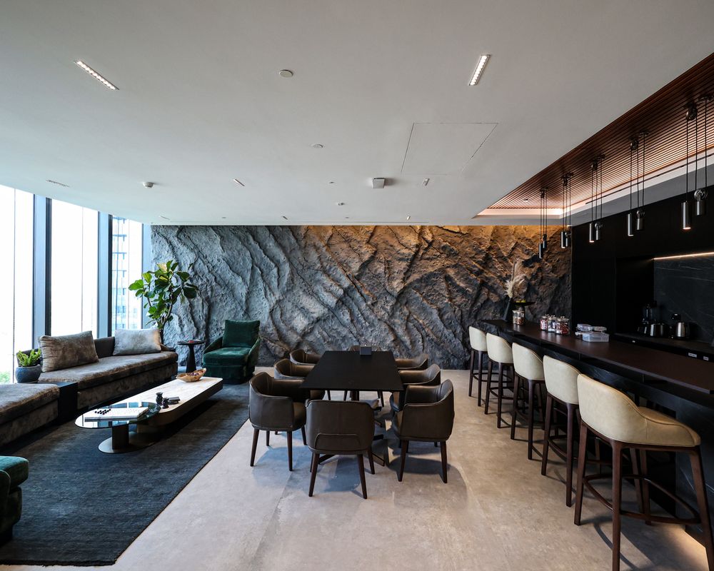 Mood lighting at IMI, One Za'abeel: a lounge and bar under pendants against a carved stone wall
