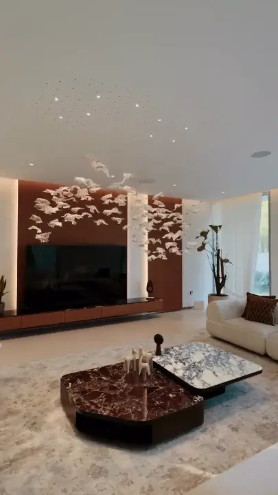 Finished villa living room with a leaf chandelier, from a Fajr Interiors walkthrough film, Dubai