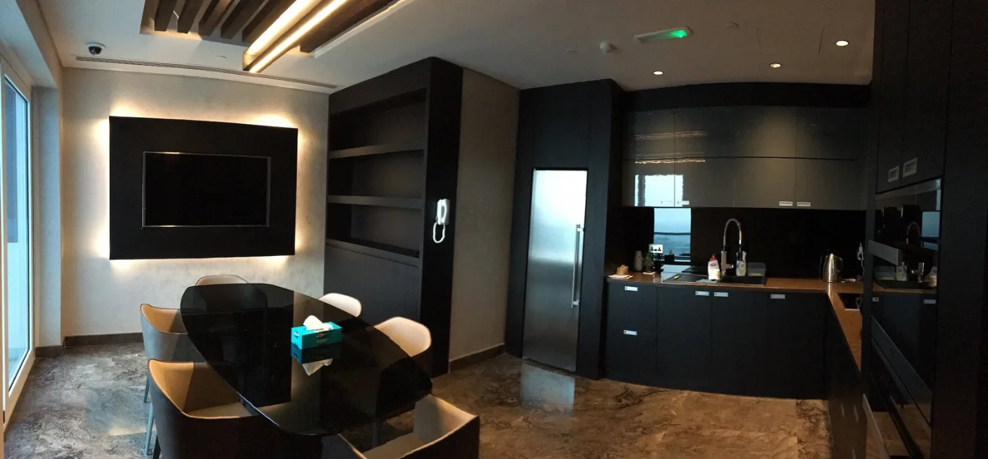 Executive lounge with a media wall and dark joinery, delivered by Fajr Interiors for ASI, Dubai