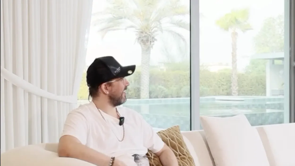Wyll, the owner of Villa 47 Fairways, at home by the pool window, Dubai Hills