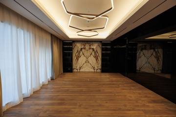 Boardroom at Crypto One: a book-matched marble feature wall, timber floor and stepped lit ceiling