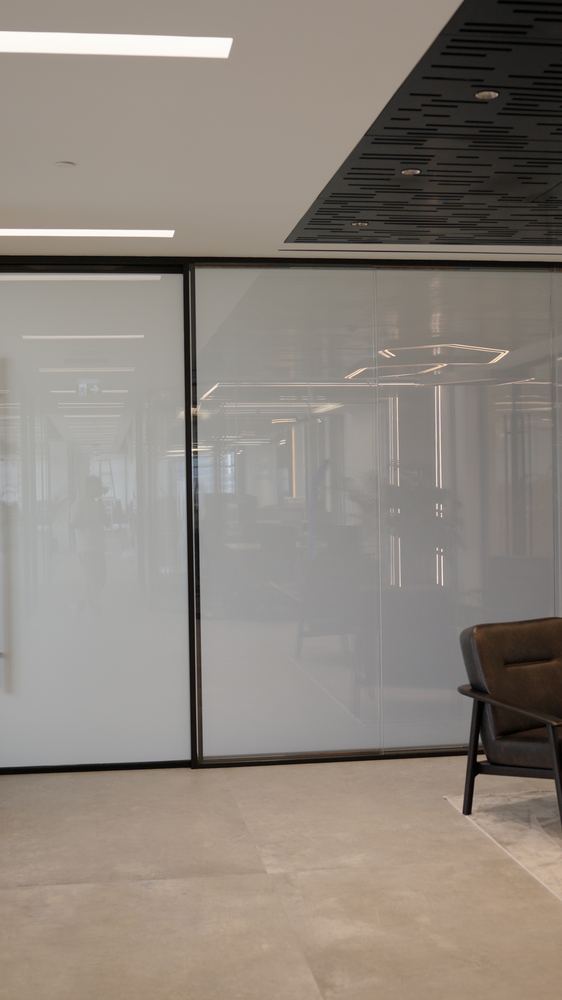 Switchable glass partition on an office floor fitted by Fajr Interiors, Dubai
