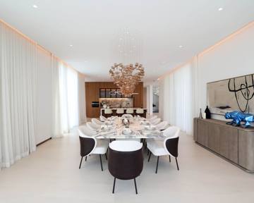 Dining room at Villa 47 Fairways: a marble table under a sculptural pendant