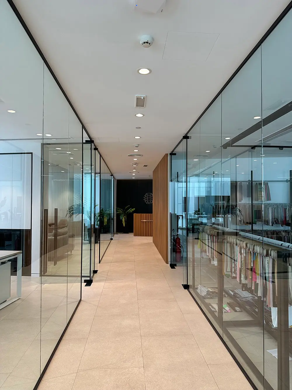 Glass-walled corridor between offices, delivered by Fajr Interiors for Global Textiles, Dubai
