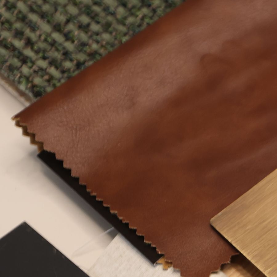 Leather, tweed and bouclé samples on the studio table at Fajr Interiors