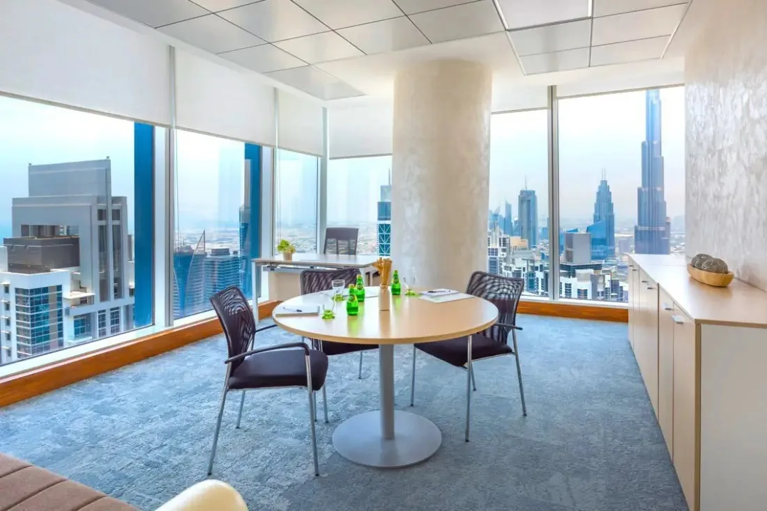 Meeting room with a round table and a view over the Sheikh Zayed Road towers, Serene office, Vision Tower, Dubai