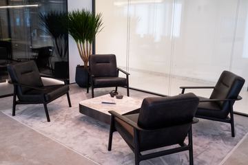 Photograph: lounge chairs and stone table, the IMI at One Za'abeel office fitout by Fajr Interiors