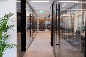 Photograph: glass-fronted rooms and planting, the IMI at One Za'abeel office fitout by Fajr Interiors