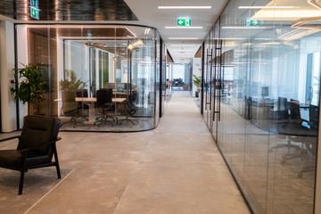 Photograph: glass offices along the corridor, the IMI at One Za'abeel office fitout by Fajr Interiors