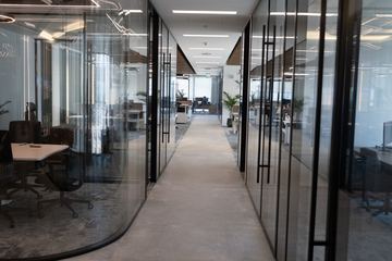 Photograph: the corridor and curved glass, the IMI at One Za'abeel office fitout by Fajr Interiors