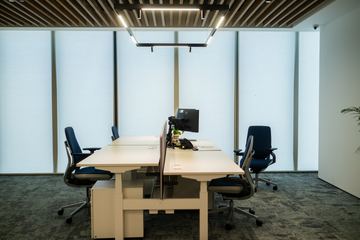 Photograph: workstations by the window, the IMI at One Za'abeel office fitout by Fajr Interiors