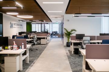 Photograph: the work floor and the company wall, the IMI at One Za'abeel office fitout by Fajr Interiors