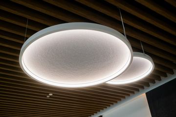 Photograph: ring pendant lights under the timber slats, the IMI at One Za'abeel office fitout by Fajr Interiors