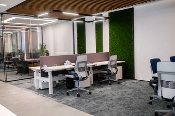 Photograph: workstations and green wall, the IMI at One Za'abeel office fitout by Fajr Interiors