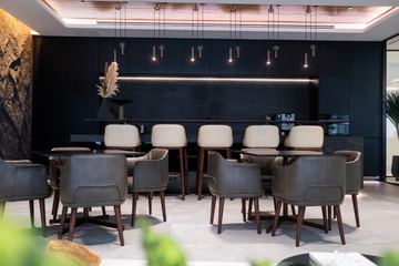 Photograph: the social space, counter and pendant lights, the IMI at One Za'abeel office fitout by Fajr Interiors