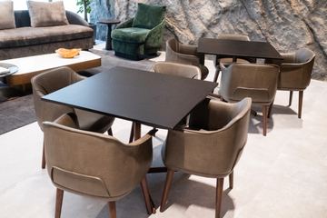 Photograph: tables in the social space, the IMI at One Za'abeel office fitout by Fajr Interiors