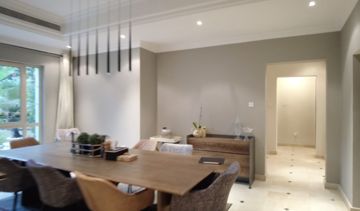 Photo: the dining room before the works, a timber table under linear pendant lights, Cluster 39, Villa 1, Jumeirah Islands