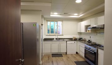 Photo: the kitchen before the works, white cabinets, a steel fridge and a range cooker, Cluster 39, Villa 1, Jumeirah Islands