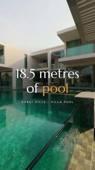 A long villa pool with a jacuzzi and swim-up bar in Dubai Hills, from a Fajr Interiors reel